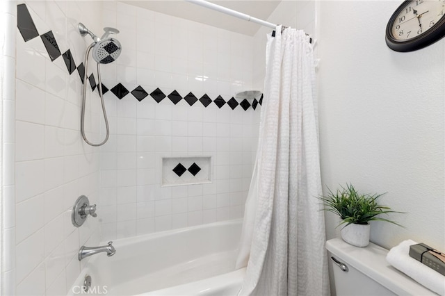 bathroom featuring toilet and shower / bath combo