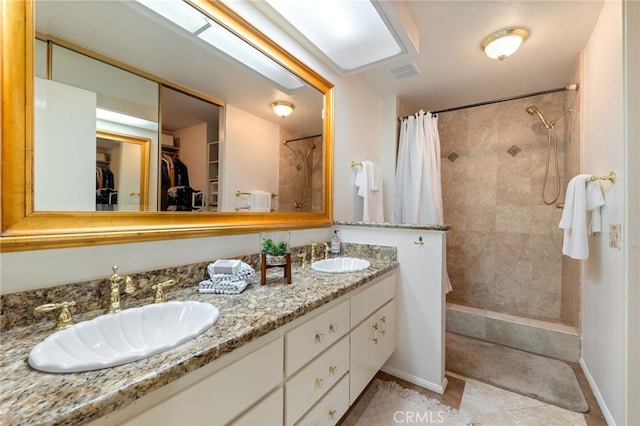 bathroom with vanity, tile patterned floors, and curtained shower