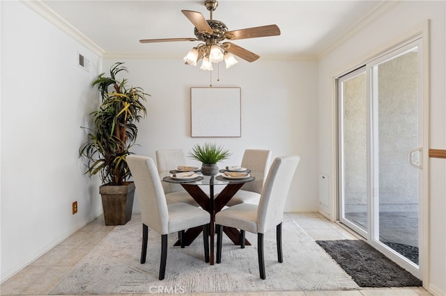 dining room with light tile patterned floors, ornamental molding, and ceiling fan