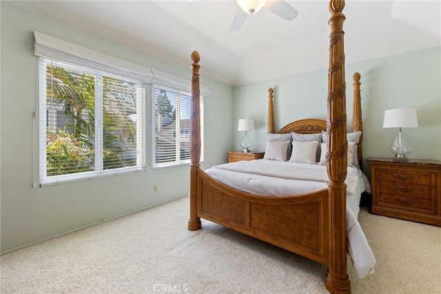 bedroom with vaulted ceiling, ceiling fan, and light colored carpet