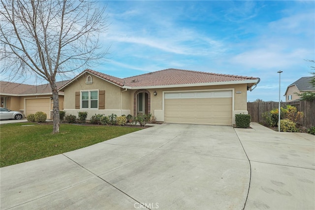 ranch-style house featuring a garage and a front yard