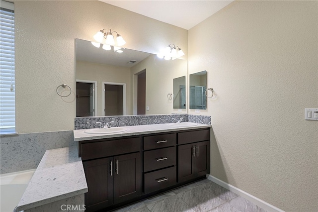 bathroom featuring tasteful backsplash and vanity