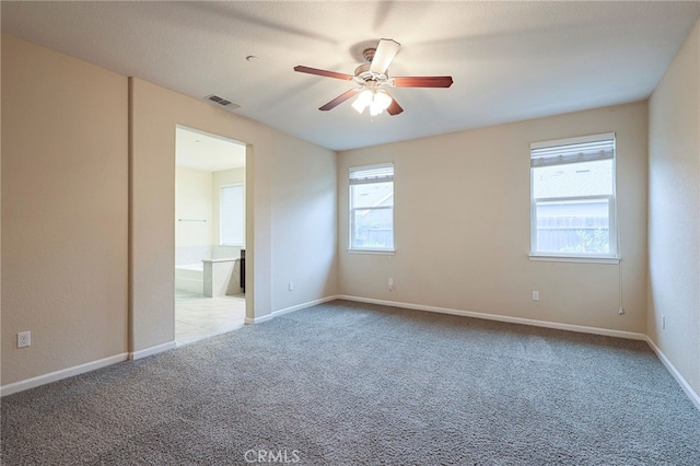 unfurnished bedroom featuring ceiling fan, connected bathroom, and carpet flooring