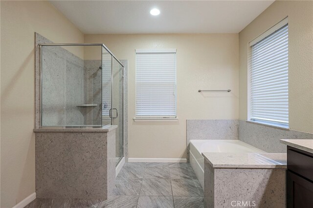 bathroom with vanity and independent shower and bath