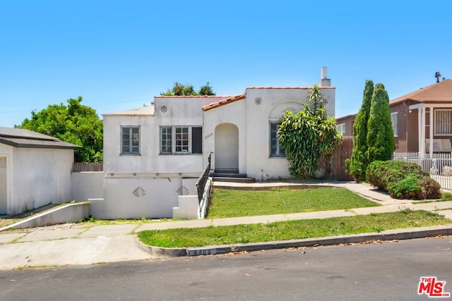 mediterranean / spanish-style house featuring a front lawn