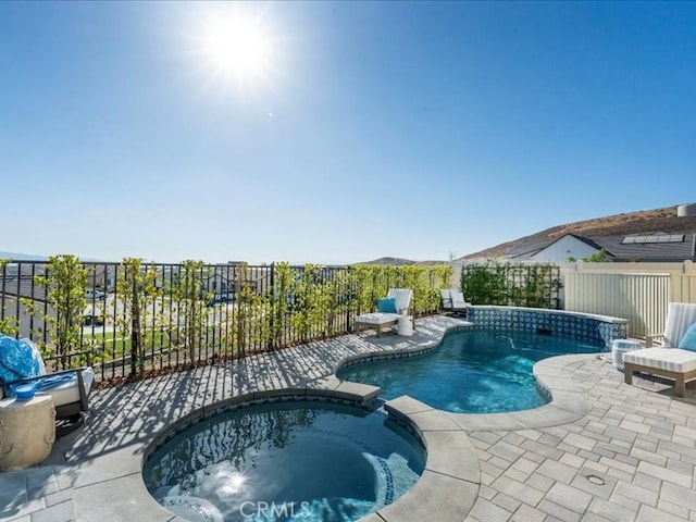 view of pool featuring an in ground hot tub and a patio area