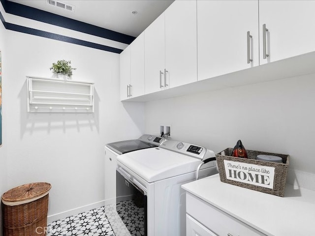 laundry room featuring cabinets and washing machine and dryer