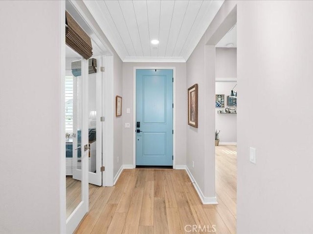 foyer entrance with wood ceiling and light hardwood / wood-style flooring