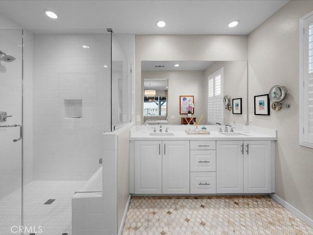 bathroom featuring walk in shower and vanity