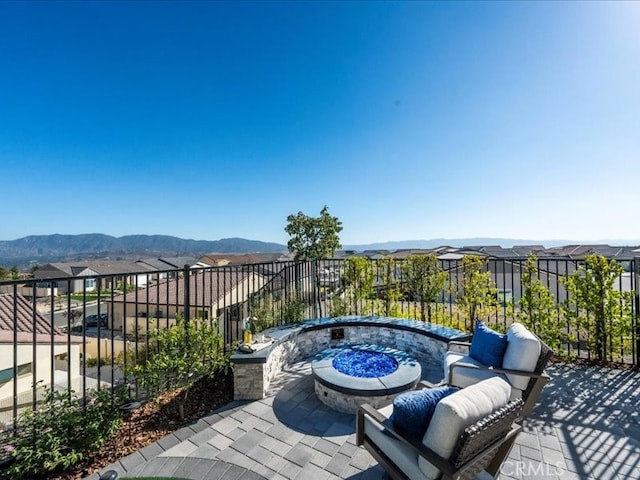 view of patio featuring a mountain view and an outdoor fire pit