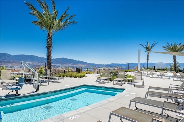 view of pool featuring a mountain view and a patio area