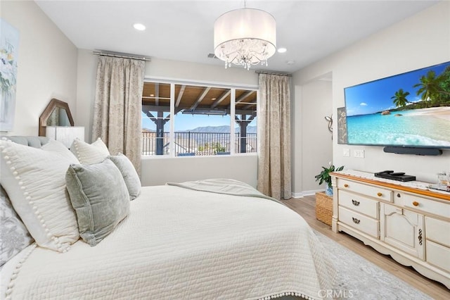 bedroom featuring a chandelier and light wood-type flooring