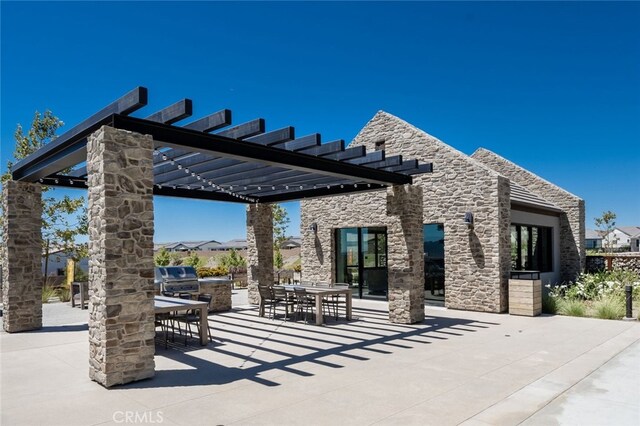 view of patio / terrace with area for grilling, a grill, and a pergola