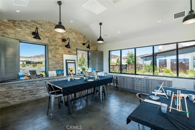 dining room featuring vaulted ceiling and plenty of natural light