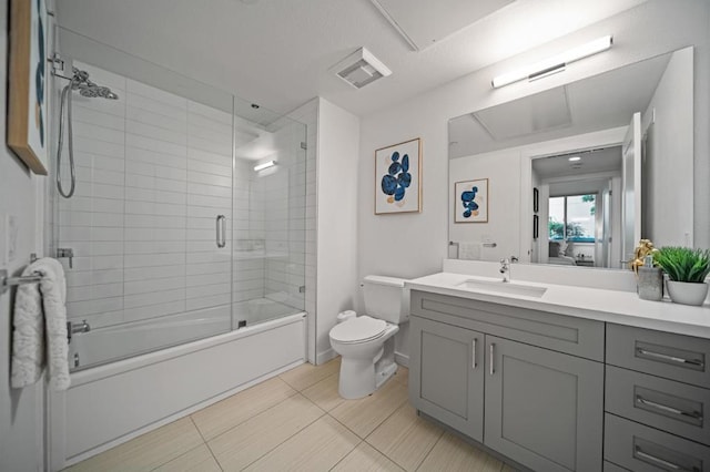 full bathroom with toilet, vanity, tile patterned flooring, and combined bath / shower with glass door