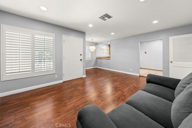 living room with hardwood / wood-style floors and a notable chandelier