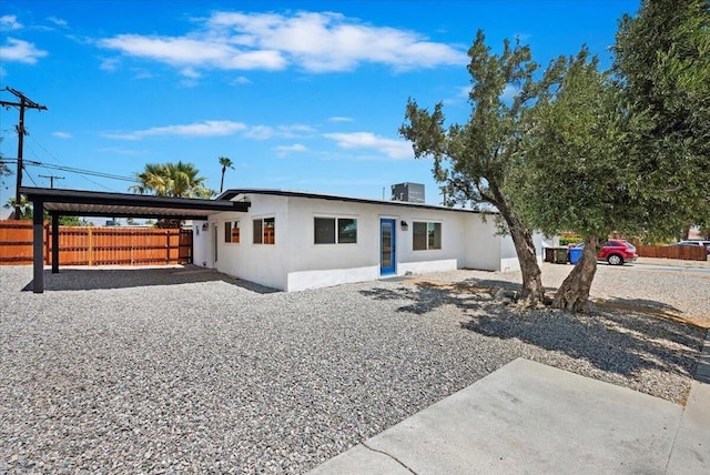 view of front of property featuring cooling unit and a carport