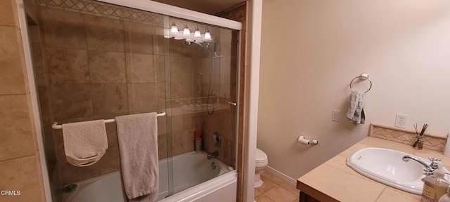 full bathroom with bath / shower combo with glass door, tile patterned floors, toilet, and vanity