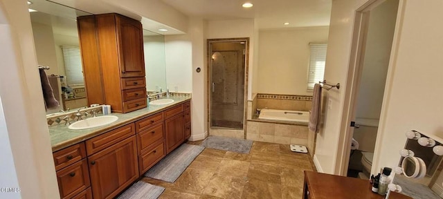 full bathroom featuring toilet, shower with separate bathtub, and vanity