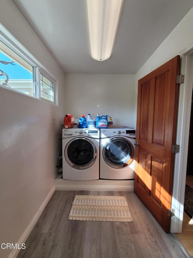 washroom with washer and dryer and wood-type flooring