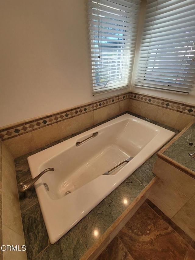 bathroom featuring tiled bath