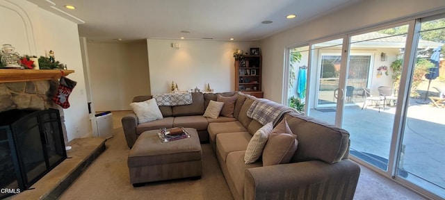 living room featuring a stone fireplace