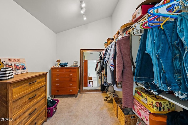 walk in closet with lofted ceiling and carpet flooring