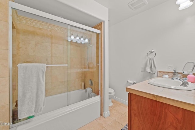 bathroom with visible vents, toilet, tile patterned flooring, bath / shower combo with glass door, and vanity