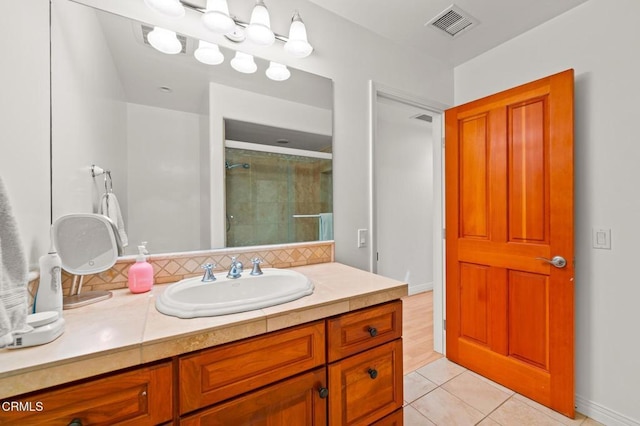 full bath featuring visible vents, a stall shower, backsplash, tile patterned flooring, and vanity