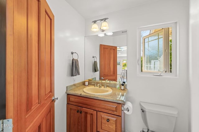 half bathroom with toilet and vanity