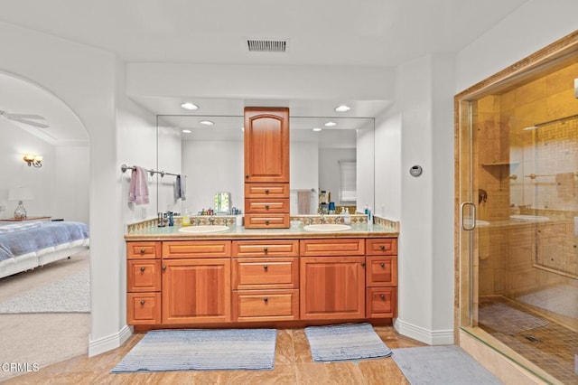 ensuite bathroom featuring ensuite bath, visible vents, a shower stall, and a sink