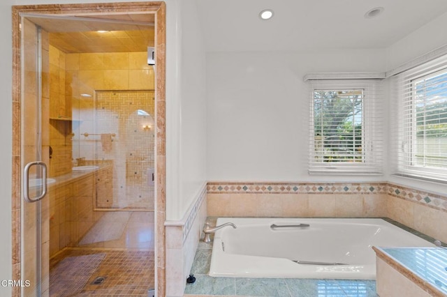 full bath featuring recessed lighting, a garden tub, and a shower stall