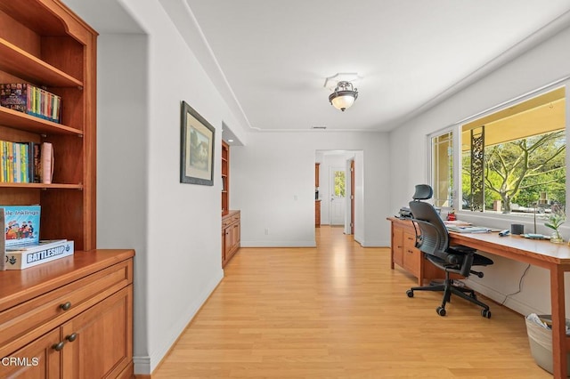 office space featuring visible vents, light wood-style flooring, and baseboards