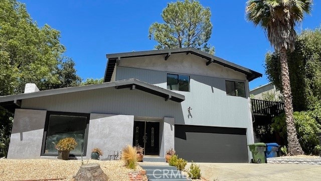 back of property featuring a garage