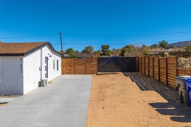 view of yard featuring central AC unit and a patio area