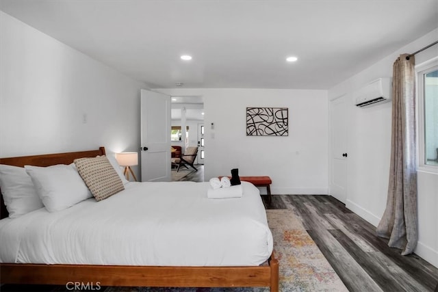 bedroom featuring dark hardwood / wood-style floors and a wall mounted AC