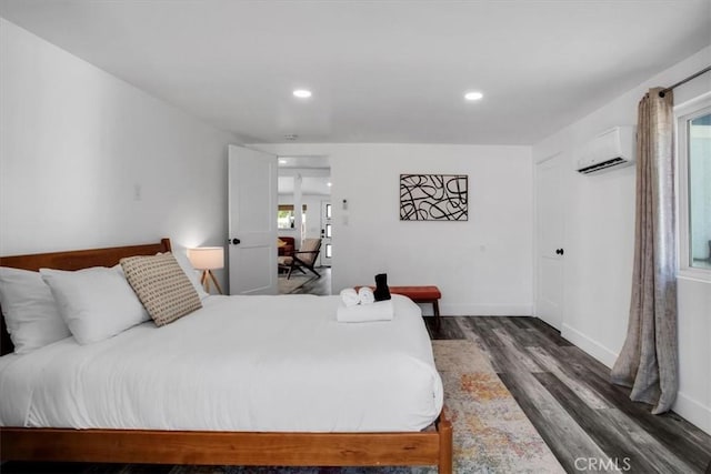 61853 Grand View Cir, Joshua Tree, CA 92252 - bedroom with baseboards, wood finished floors, a wall mounted AC, and recessed lighting