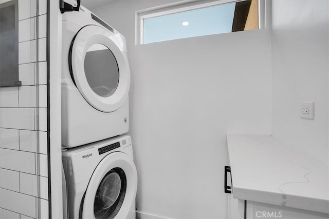 clothes washing area featuring stacked washer and dryer