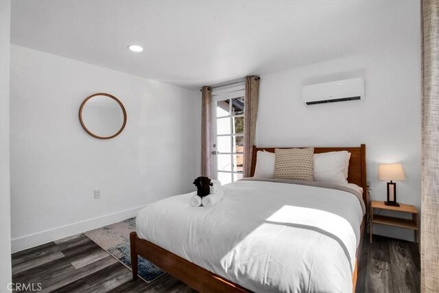 61853 Grand View Cir, Joshua Tree, CA 92252 - bedroom with baseboards, wood finished floors, an AC wall unit, and recessed lighting