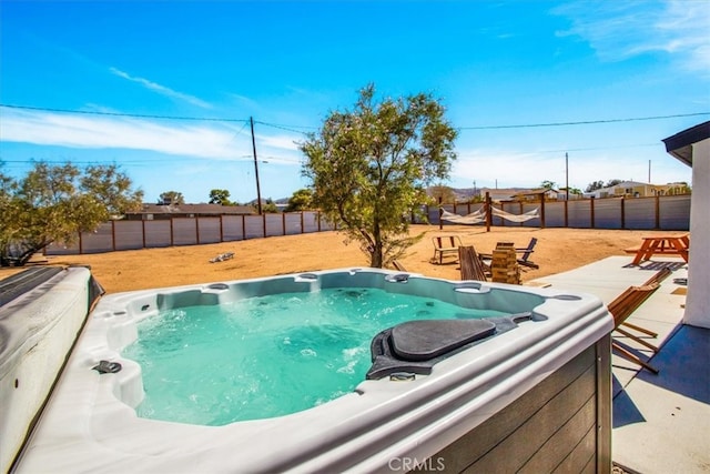 view of pool with a patio and a hot tub