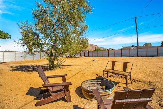 61853 Grand View Cir, Joshua Tree, CA 92252 - view of patio featuring fence and an outdoor fire pit