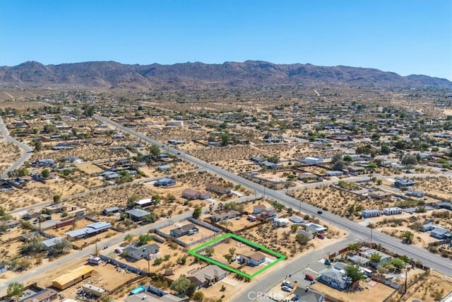 birds eye view of property featuring a mountain view