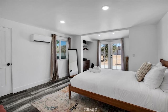 61853 Grand View Cir, Joshua Tree, CA 92252 - bedroom with access to outside, french doors, multiple windows, a wall unit AC, and wood finished floors