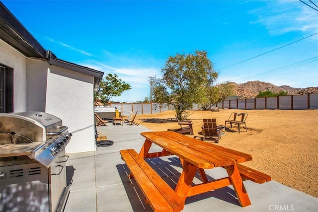 view of patio / terrace featuring a mountain view and a grill