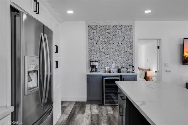 61853 Grand View Cir, Joshua Tree, CA 92252 - kitchen featuring stainless steel refrigerator with ice dispenser, wood finished floors, light stone counters, beverage cooler, and backsplash