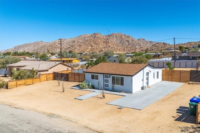 61853 Grand View Cir, Joshua Tree, CA 92252 - ranch-style home with a mountain view, fence, a residential view, and stucco siding