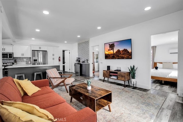 living room with light wood-type flooring and a wall mounted AC