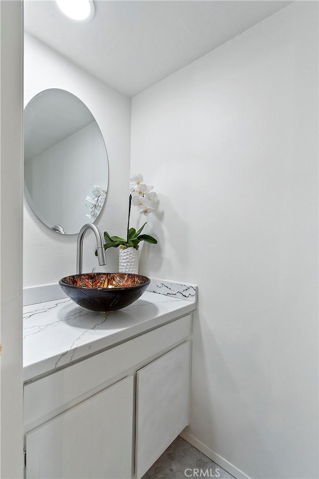 bathroom with vanity and baseboards