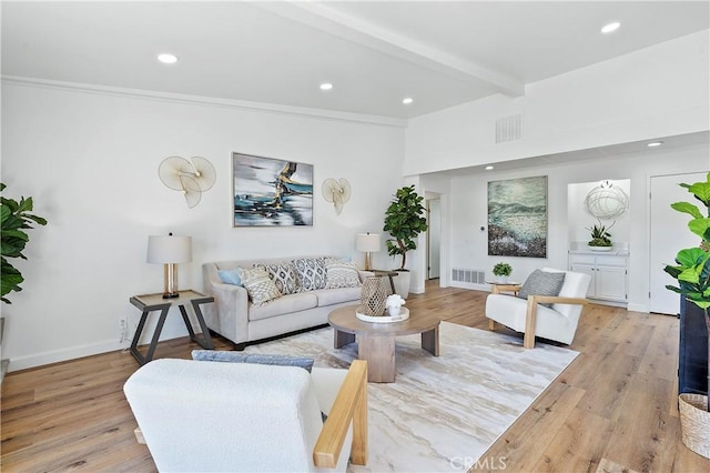 living area with light wood-style flooring, visible vents, beam ceiling, and recessed lighting