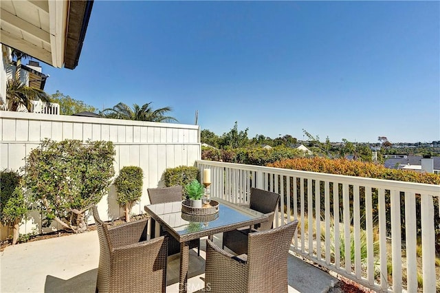 view of patio with outdoor dining area and fence